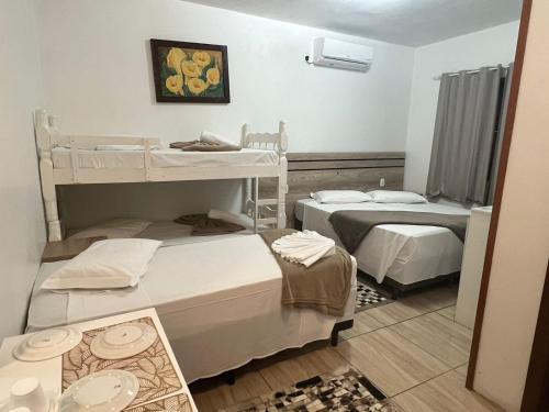 a room with two bunk beds and a mirror at Pousada Schmitz in Canela