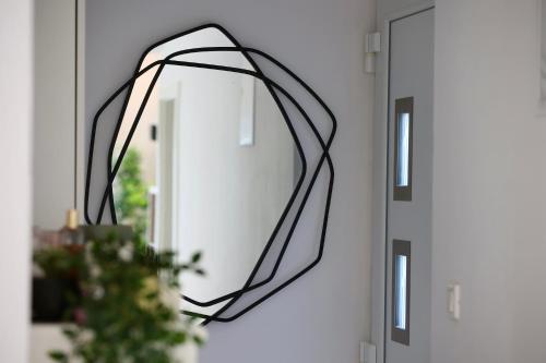 a wreath hanging on a mirror next to a door at Holiday Home TiA in Split