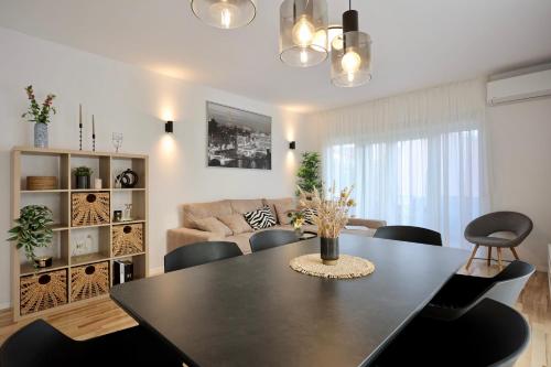 a living room with a black table and chairs at Holiday Home TiA in Split