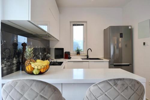 a kitchen with a bowl of fruit on a counter at Holiday Home TiA in Split
