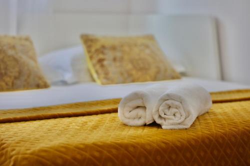 a pair of towels laying on a bed at Holiday Home TiA in Split