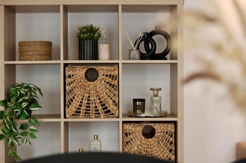 a book shelf with baskets and bottles on it at Holiday Home TiA in Split