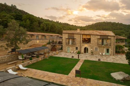 an aerial view of a house with a lawn at ECOTurisme Can Buch HOTEL in Sant Aniol de Finestras