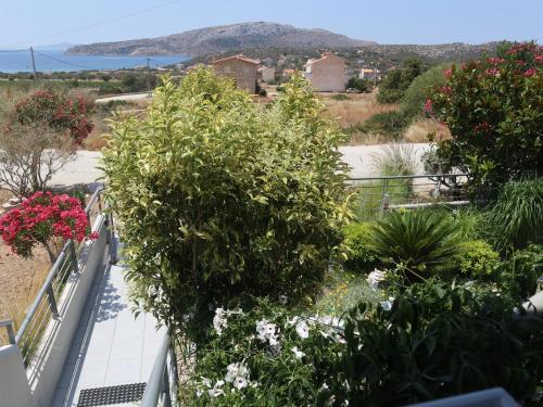 a balcony with flowers and plants on it at Patroclos SeaView in Sounio