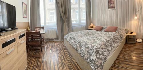 a bedroom with a bed and a flat screen tv at Prague Old Town Apartment Benediktska 6 in Prague