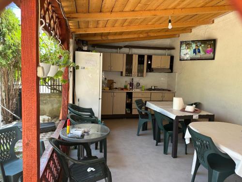 cocina y comedor con mesas y sillas en Vila Vio 2 camere independente, en Eforie Nord