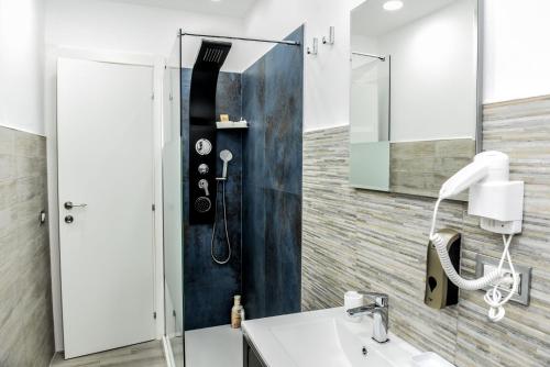 a bathroom with a shower and a sink at La Via Di Mezzo in Catania