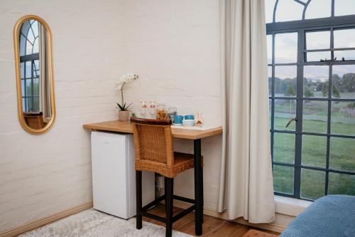 a desk in a room with a window at Mooi Uitsig Lodge in Paarl