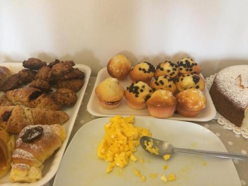a table with different types of pastries on plates at B&B Indipendenza in Civitanova Marche