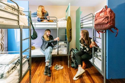two girls sitting on bunk beds in a hostel at Samesun Ocean Beach in San Diego