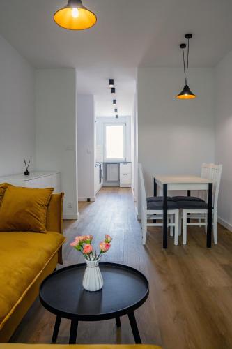 a living room with a couch and a table at Apartament Alpaka 1 in Lidzbark Warmiński