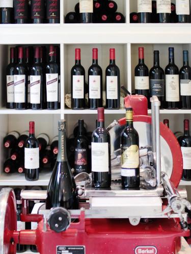a shelf filled with lots of bottles of wine at Hotel La Pigna in Marina di Pietrasanta