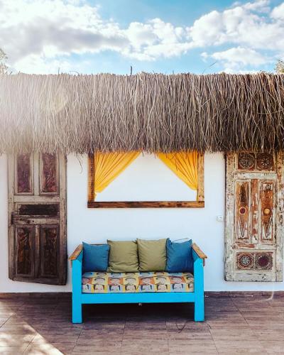 a blue couch sitting on the side of a building at ELIES TINY GLAMPING in Ayvalık