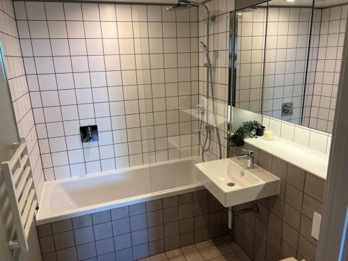 a bathroom with a bath tub and a sink at 2bedroom luxury apartment city centre in Manchester