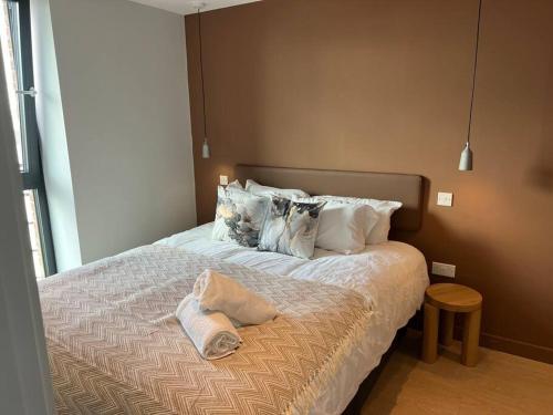 a bed with two pillows on it in a bedroom at 2bedroom luxury apartment city centre in Manchester