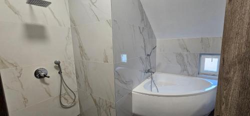 a bathroom with a white toilet and a window at Vécsey House Zamárdi in Zamárdi