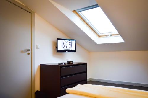 a bedroom with a bed and a skylight at CBA Suites Madeira in Funchal