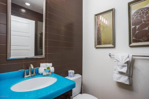 a bathroom with a blue sink and a toilet at Beach Club at Siesta Key Poolside D in Point O'Rocks