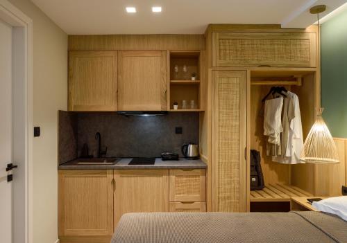 a kitchen with wooden cabinets and a sink at Evelio Living in Keramotí