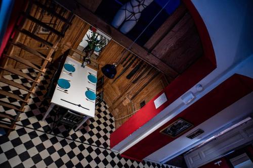an overhead view of a kitchen with a checkered floor at Vintage BDSM Kinky Apartment - ENTIRE 65m2 space for up to 6-guests - FULLY EQUIPPED in Wrocław