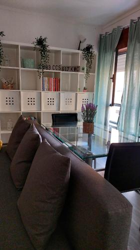 a living room with a couch and a glass table at Casa da Avó Bé in Portalegre