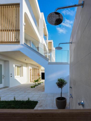 a house with white walls and a staircase at Evelio Living in Keramotí