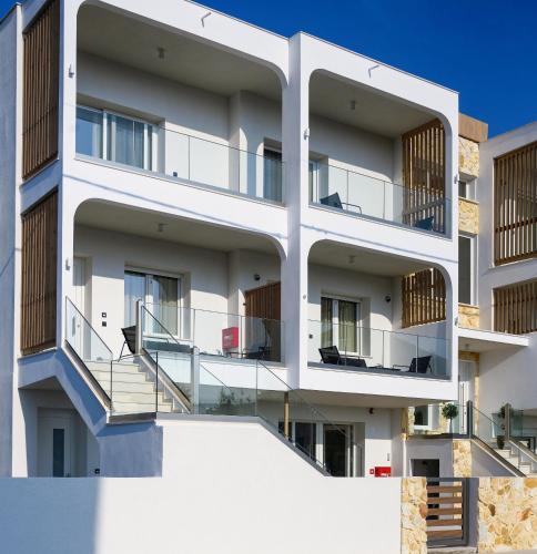 an apartment building with balconies and stairs at Evelio Living in Keramotí
