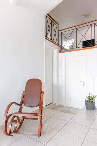 a brown chair sitting in a room with a tiled floor at A&D Houses No3 in Patra