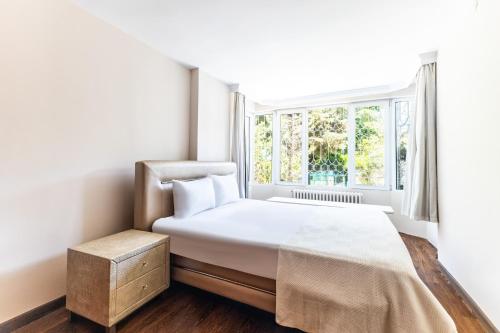 a bedroom with a bed and a window at Chic Flat w Garden in Bebek, Lux Side of Istanbul in Istanbul