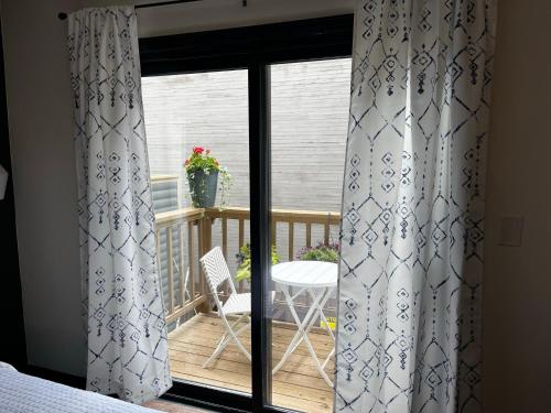 a room with a balcony with curtains and a table at Hotel Frisco in Frisco