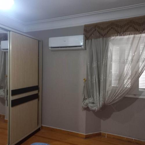 a room with a window with a curtain at Aqua Tanta Group طنطا Families Only in Tanta
