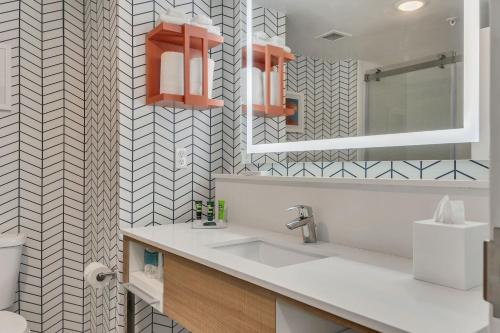 a bathroom with a sink and a mirror at Evoke Destin Hotel in Destin