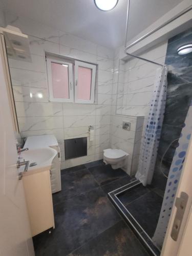 a bathroom with a toilet and a sink at Happy apartment Strumica 2 in Strumica