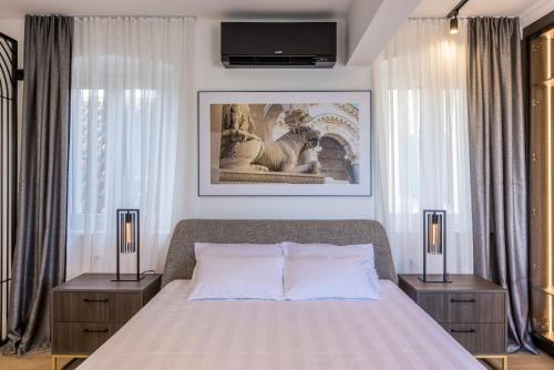 a bedroom with a large bed with two night stands at Palazzo Romano Suite 2 in Split