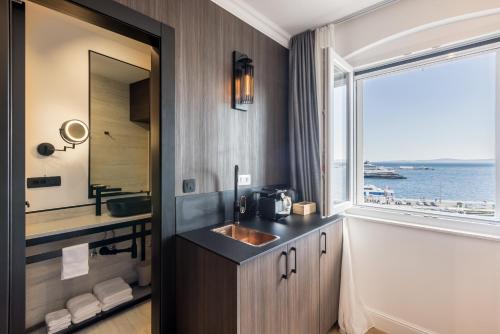 a bathroom with a sink and a large window at Palazzo Romano Suite 2 in Split
