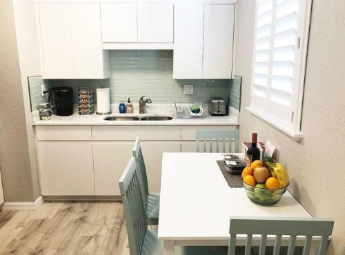 a kitchen with a bowl of fruit on a counter at Modern Apartment - 2 of 4 in Punta Gorda