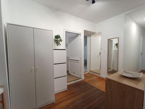 biały pokój z białymi szafkami i lustrami w obiekcie Appartements et studio rénovés en 2022, Intra Muros Avignon w Awinionie