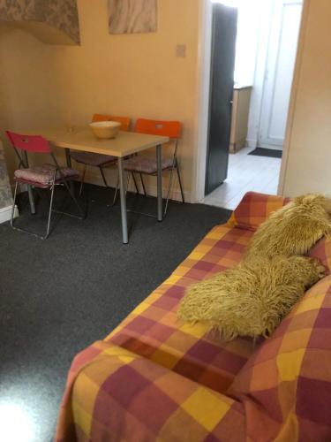 a dog laying on a bed in a room at Tatia House in Gainsborough