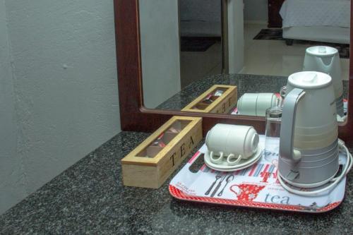 a kitchen appliance sitting on a counter in front of a mirror at Muofhe Graceland Lodge in Thohoyandou
