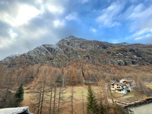a mountain with a house in front of it at La Meison in Valgrisenche