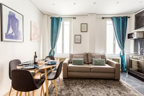 a living room with a couch and a table at Suite Paris, Tour Eiffel, Champs Elysées in Paris