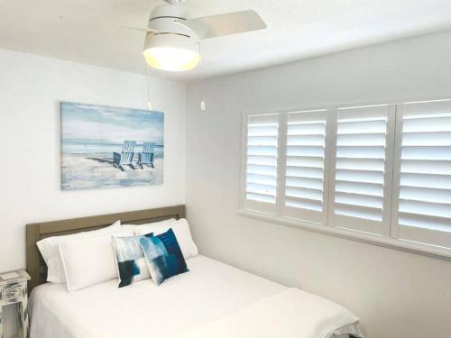 a white bedroom with a bed and a window at Modern Apartment - 4 of 4 in Punta Gorda