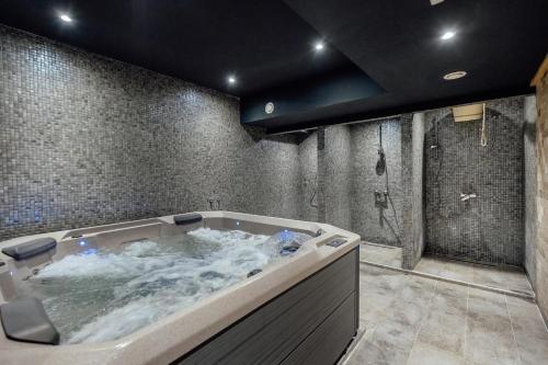 a bathroom with a large tub filled with water at HOTEL TALIA in Herceg-Novi