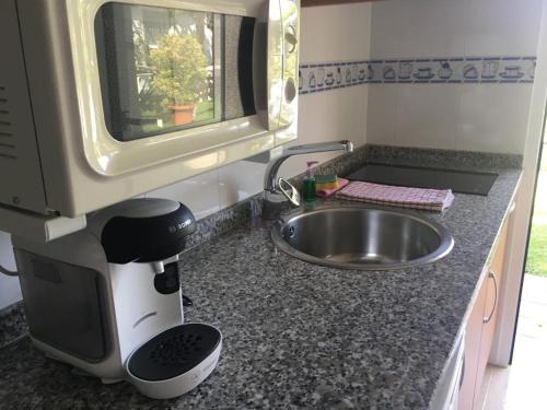 a kitchen counter with a mixer and a sink at Airiños do Mar in Areas