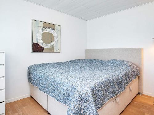 a bedroom with a bed with a blue comforter at Luxury Spa Retreat in Lolland - By Traum Ferienwohnungen in Nakskov