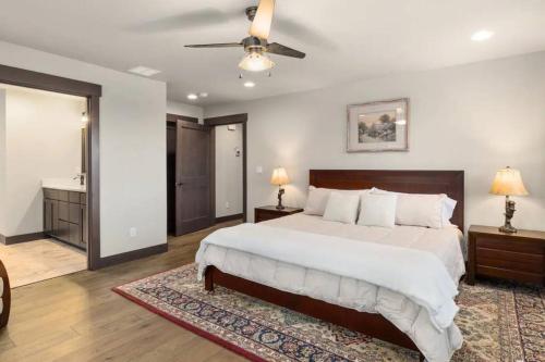 a bedroom with a large bed and a ceiling fan at Summit House in Cle Elum