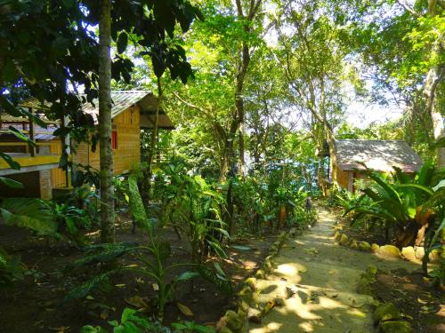a path leading to a house in the forest at Santi Garden Bungalows in Iboih
