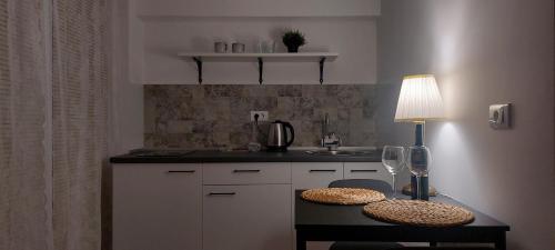 a kitchen with a table with a lamp and a sink at Apartment Sneshka in Ohrid