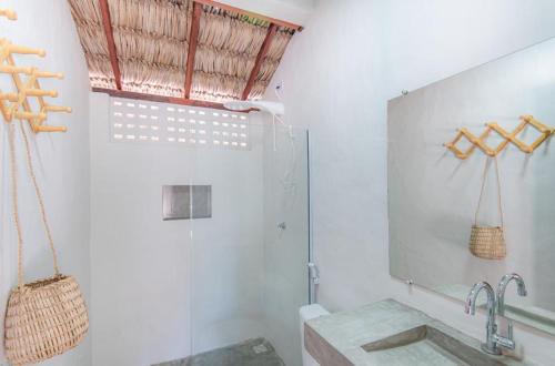 a bathroom with a sink and a mirror at Vila Viva in Barra Grande
