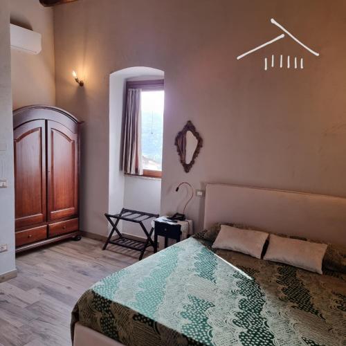 a bedroom with a bed and a window at Casa Argenti in Arrone